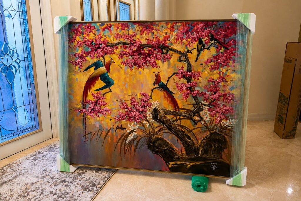 Fine art painting prepared for nationwide transportation with protective corner protection before pickup.
